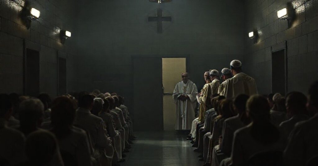 Obrązek przedstawiałż fałszywych biskupów prowadzących niereligijną ceremonie w wiaźieniach bez sakramentalnego wymiaru.