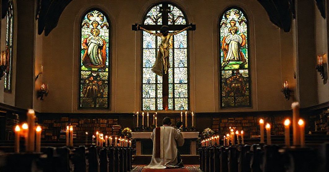 Kapelan w tradycyjnym kościele modląc się przed krzyżem w otoczeniu starych ksiąg katolickich.
