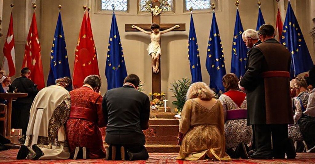 Katy Tradycyjna katolicka rodzina modli się przy krucyfiksu z flagami UE w tle symbolizującymi prześladowanie, Vincenza Bassiego i Kingę Gał w pobliżu