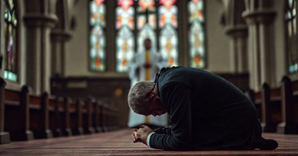Człowiek modlący się w tradycyjnym koście katolickim z wyrazem smutku i rozczarowania.